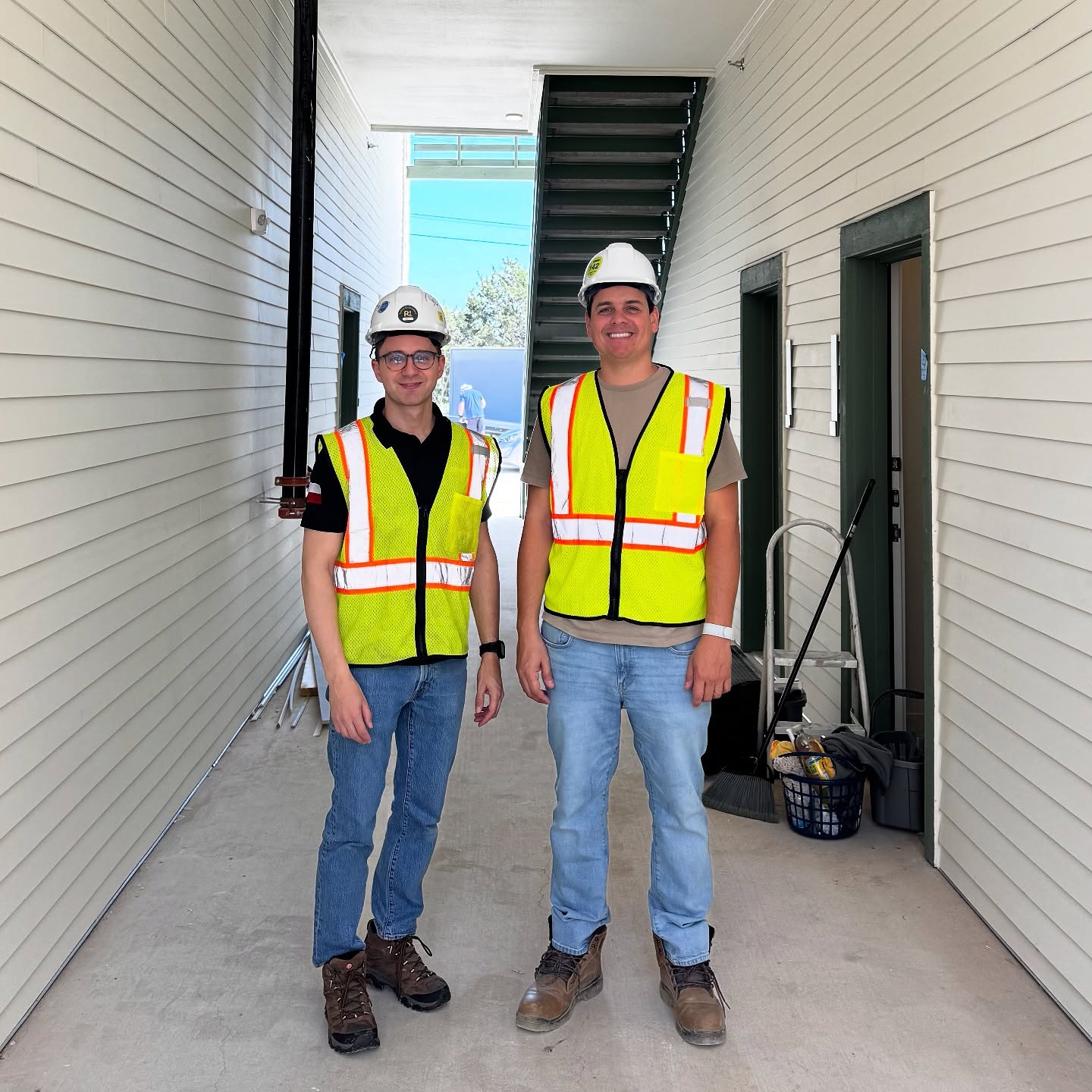 Segur Cleaning team members in branded high-visibility vests on a job site